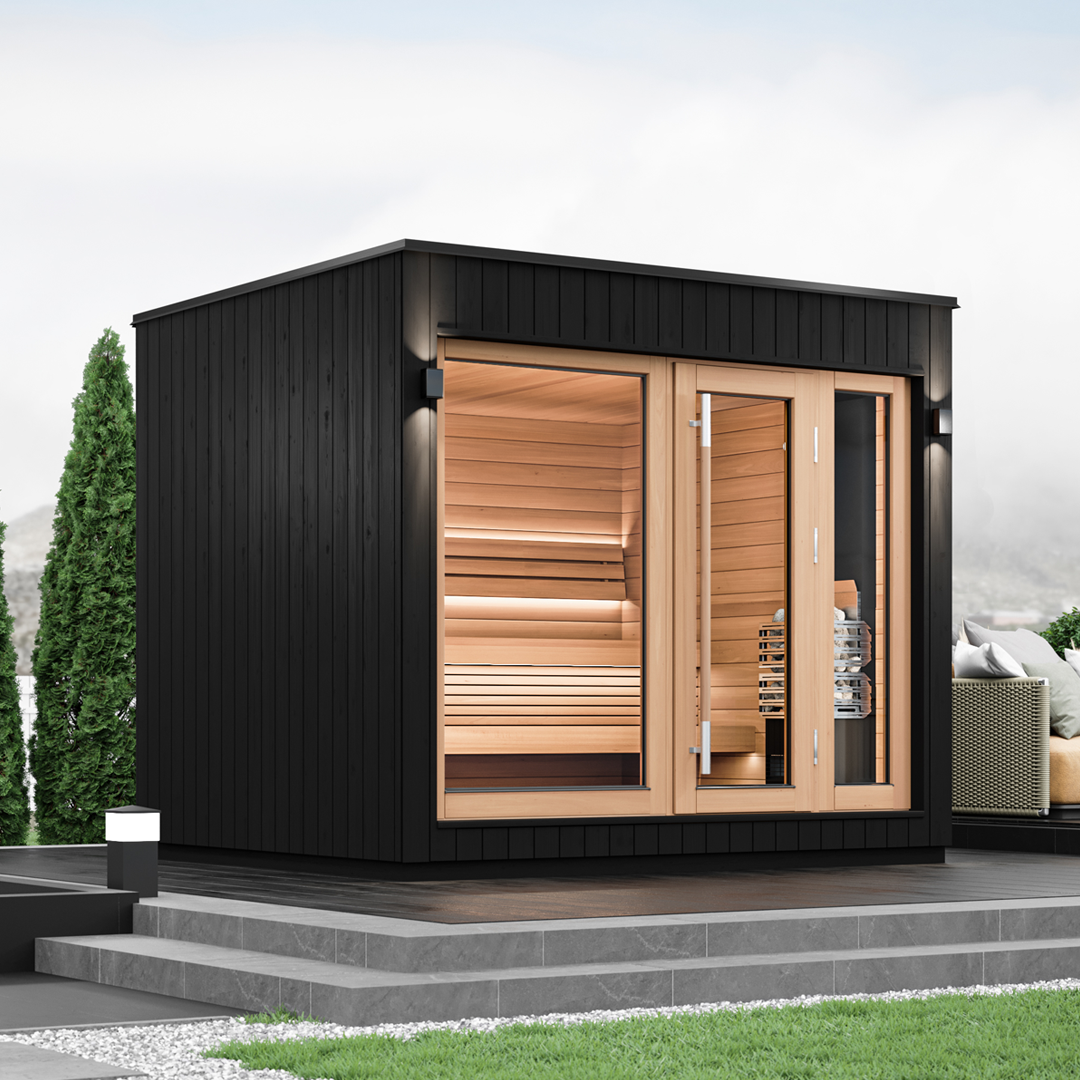 A sleek, black Saunum AirCube One outdoor sauna with clear glass doors and wooden benches visible inside.