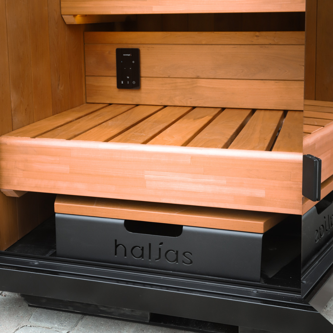 Wooden sauna bench with black base and 'haljas' branding.