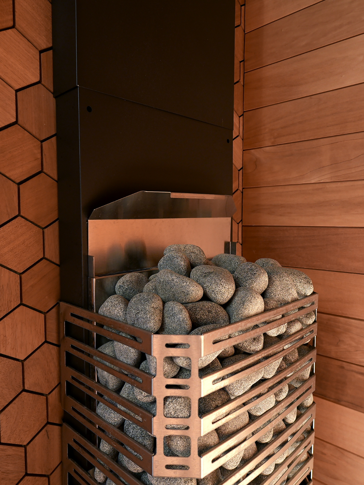 Basket of stones in a wooden sauna setup