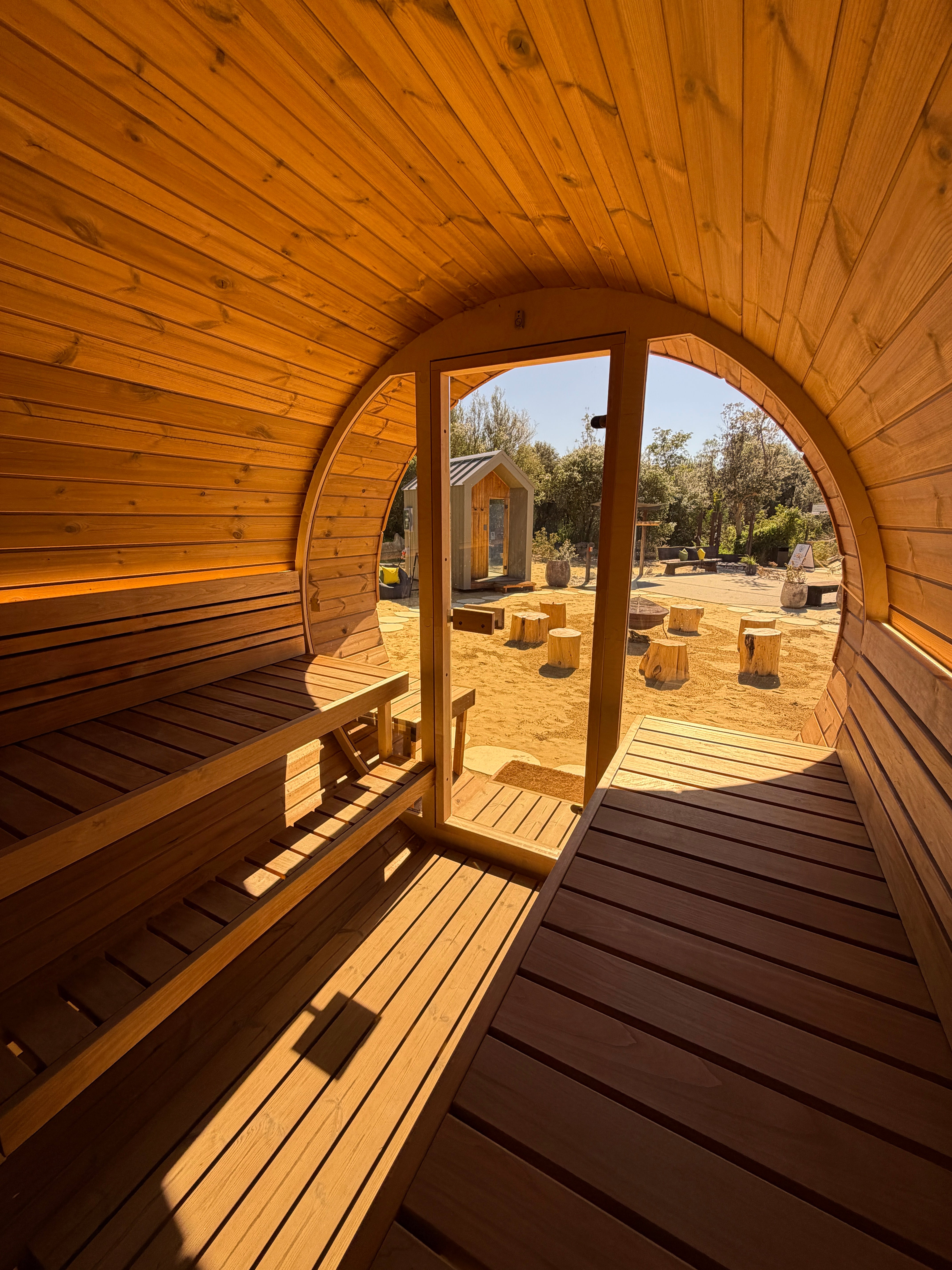 Wooden sauna interior with curved ceiling and floor
