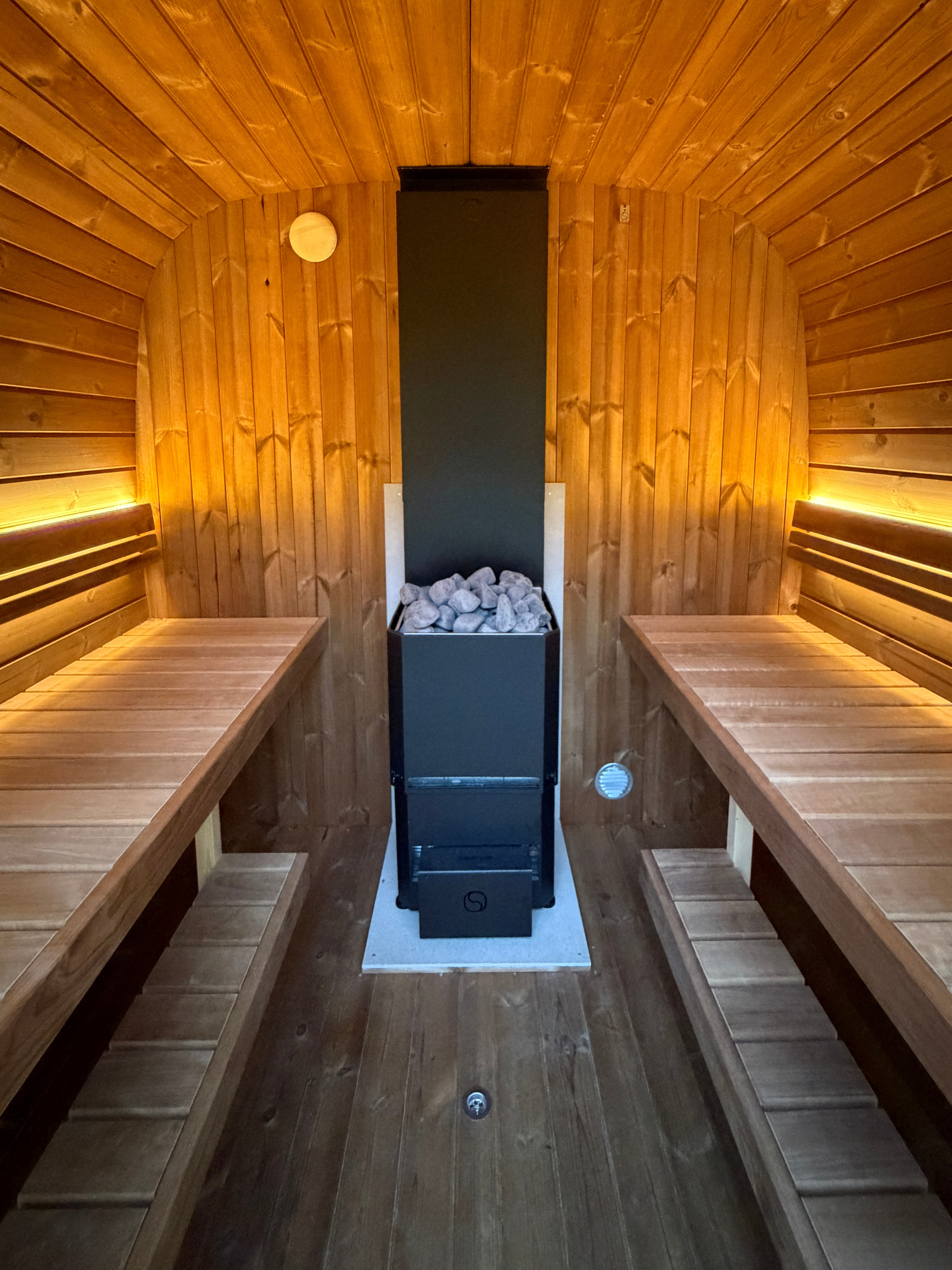 Wooden sauna with benches and a stove
