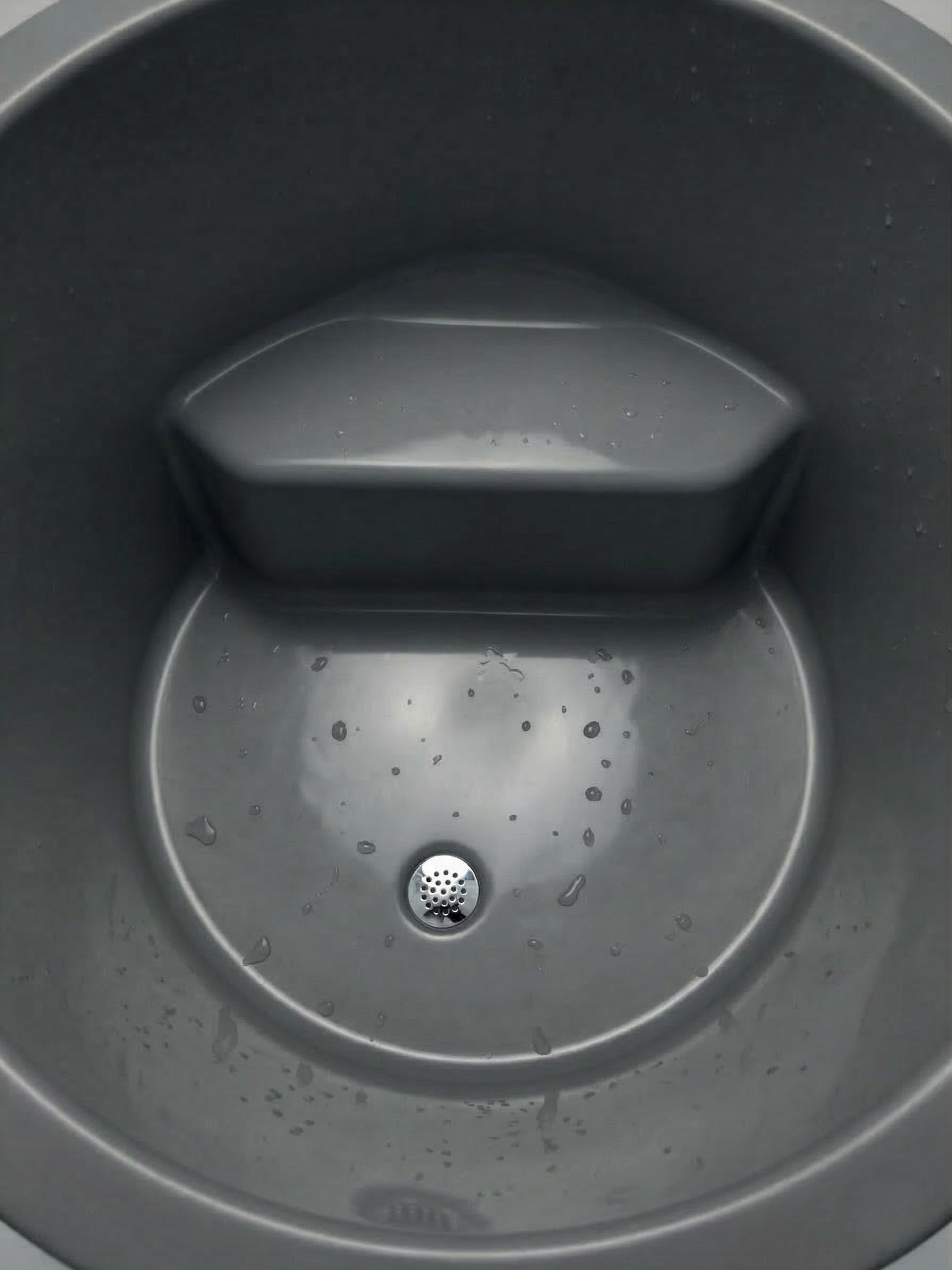 Gray sink with a drain and soap dish