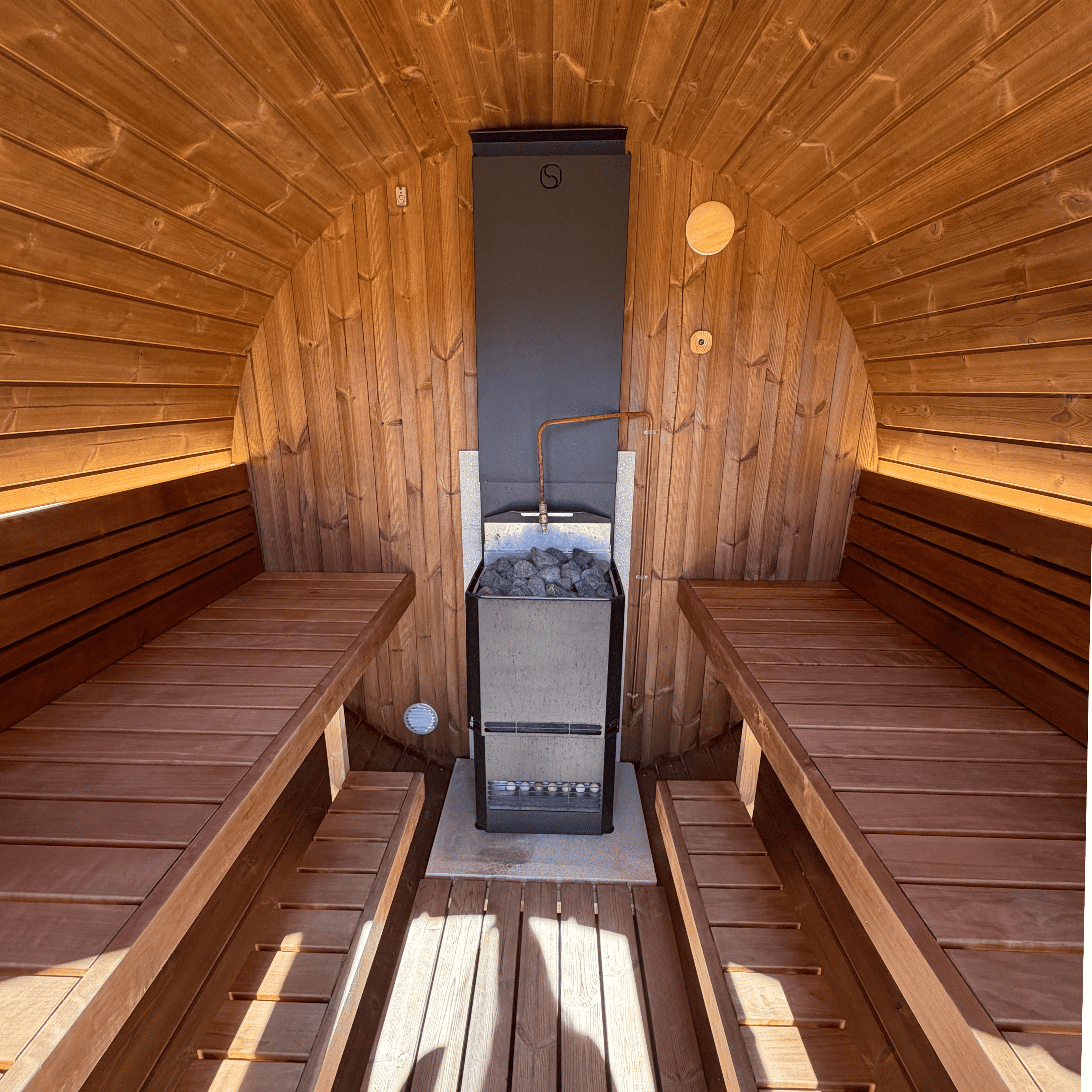 Wooden sauna with benches and a stove