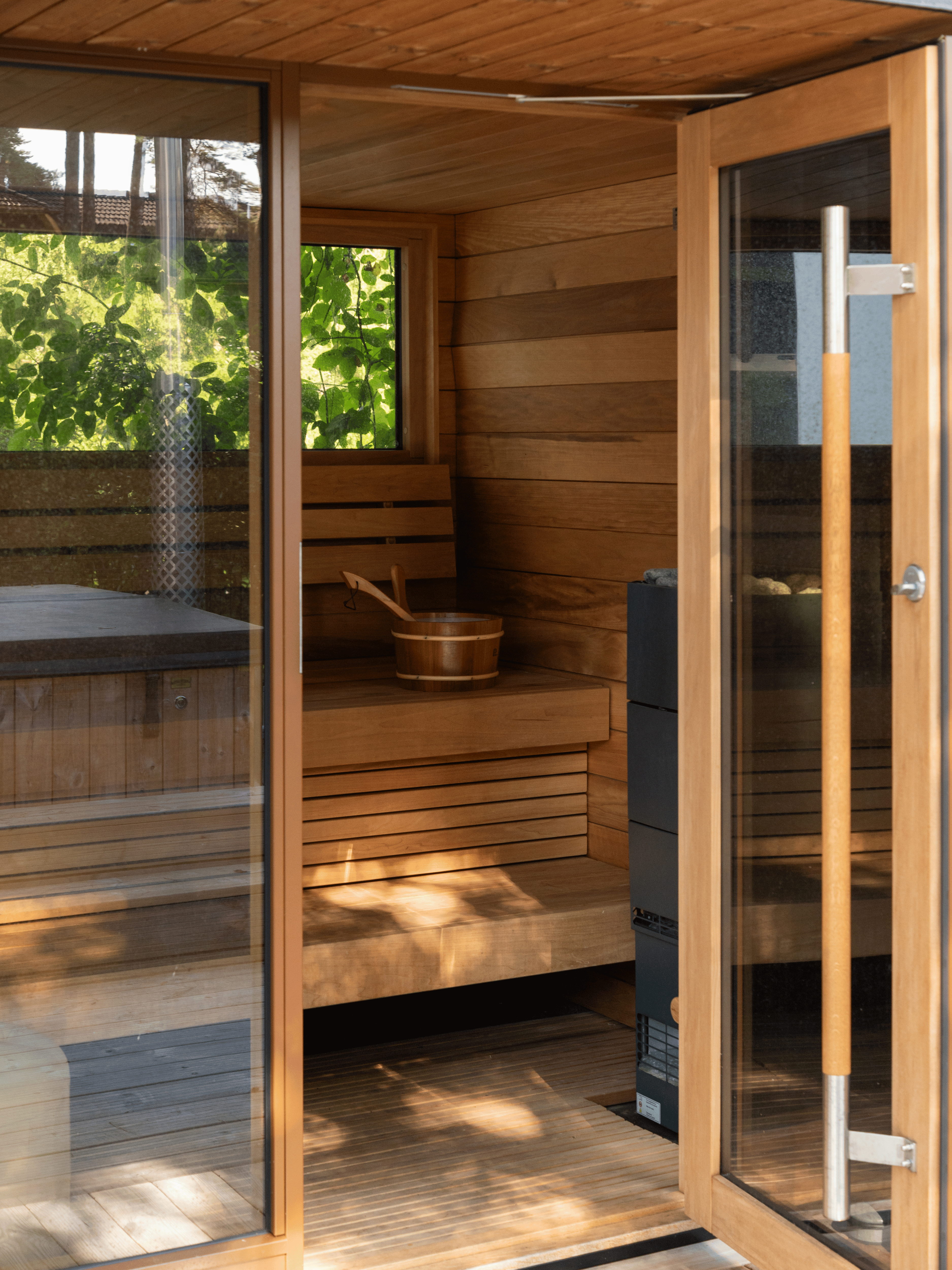 Wooden sauna with glass doors and interior details
