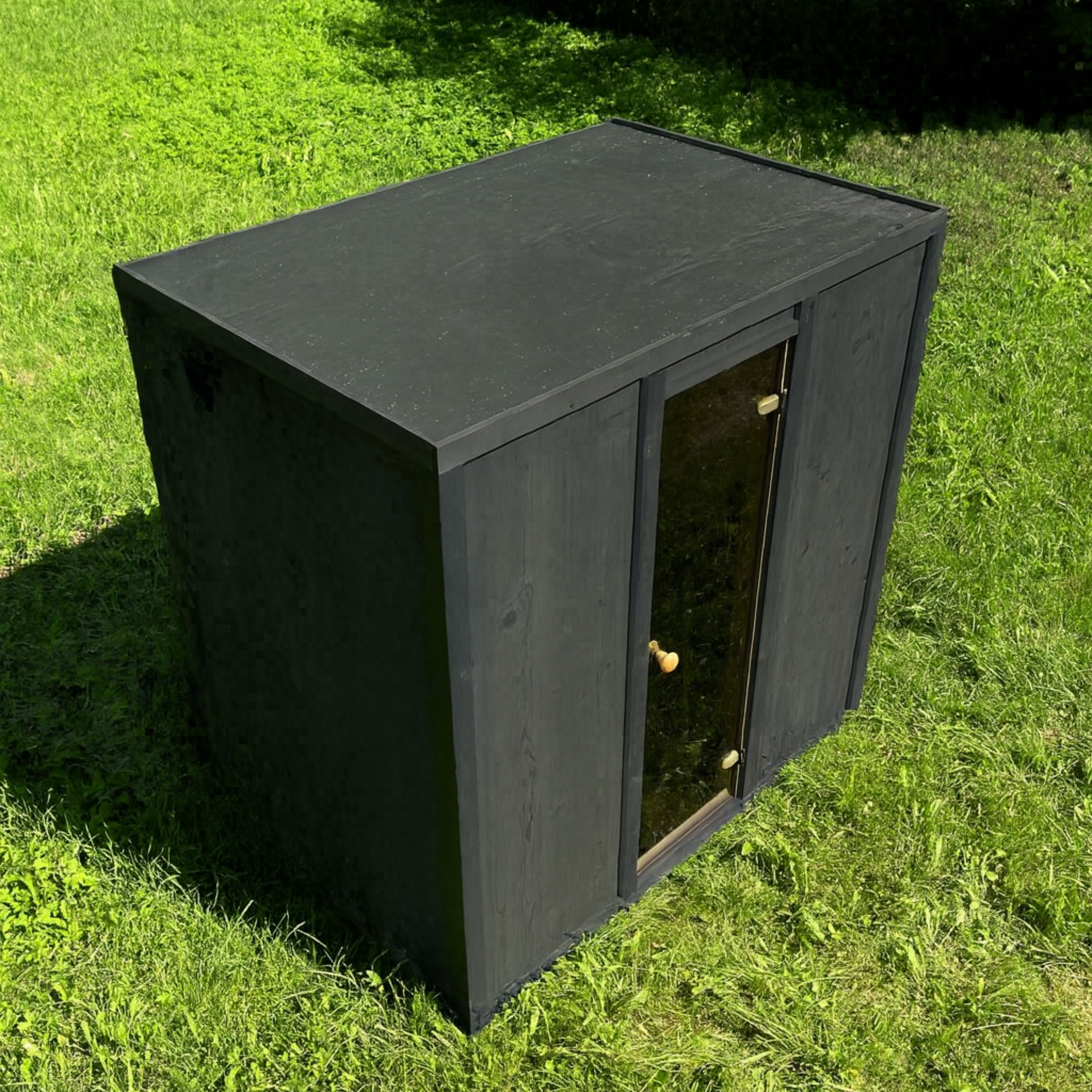 Black outdoor storage cabinet on grass