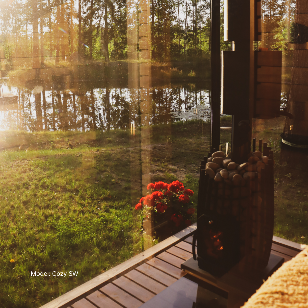 Sunset over a lake with a wooden deck and potted plants