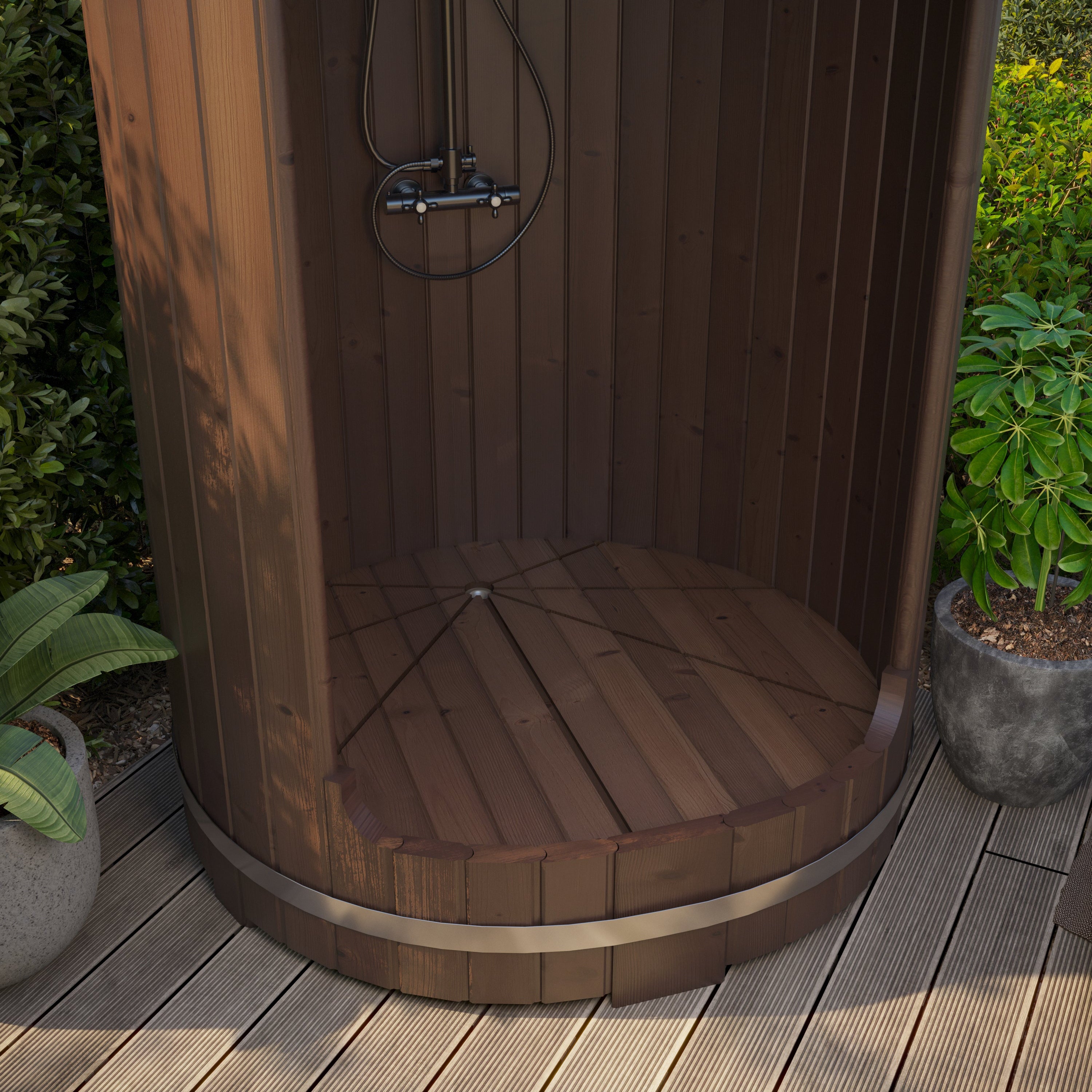 Wooden outdoor shower enclosure with plants around on a wooden deck.