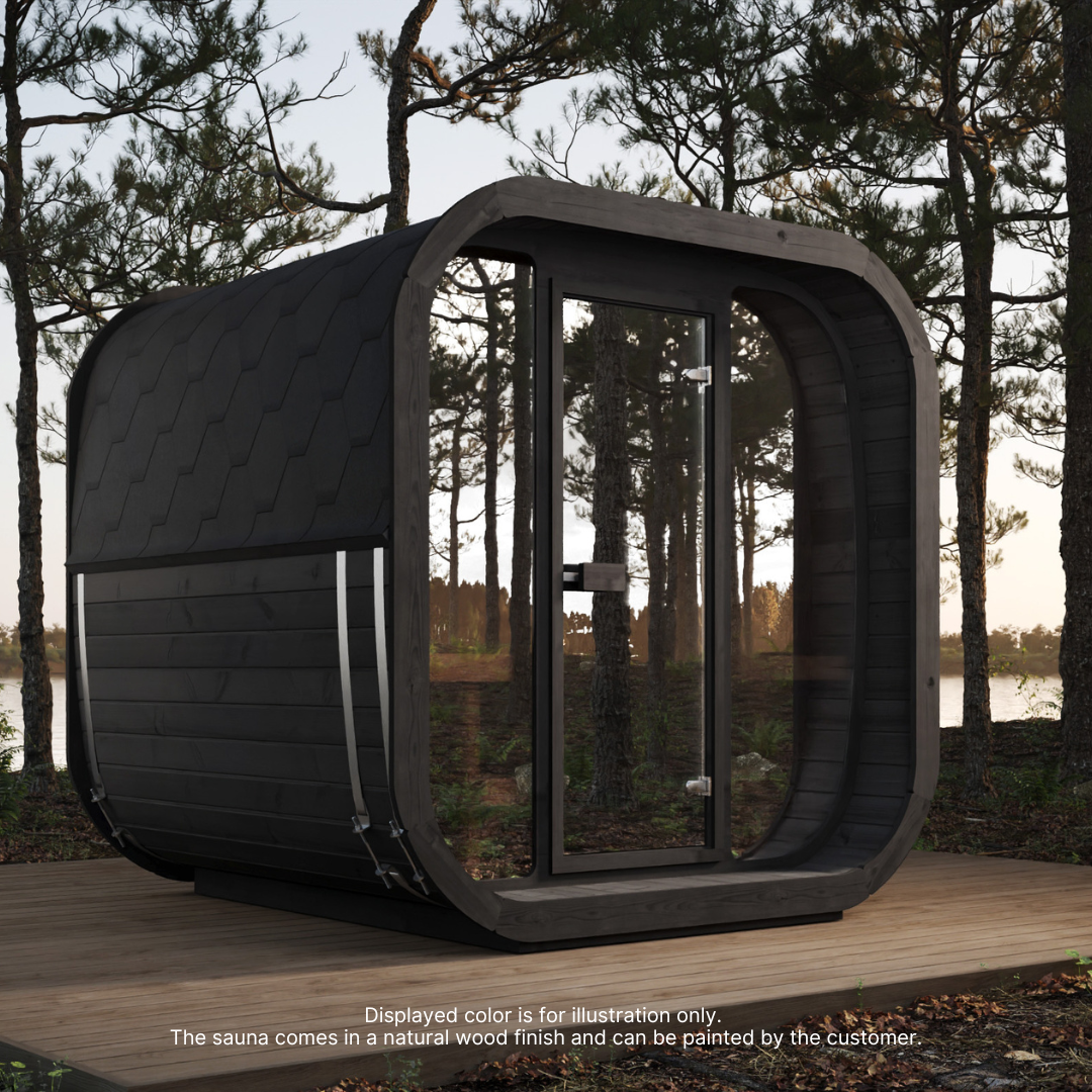 Modern black sauna with curved edges sits on a wooden deck in a serene forest setting. Tall pine trees surround the area, creating a peaceful atmosphere.
