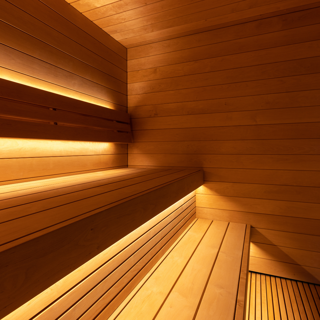 Wooden sauna interior with benches and warm lighting