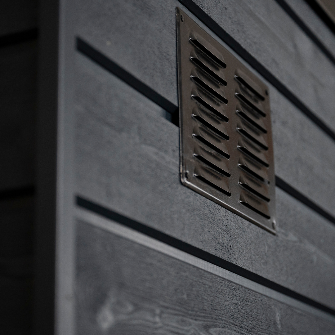 Metallic vent on a textured wall