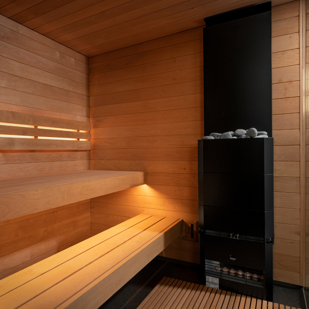 Wooden sauna with a black stove and benches