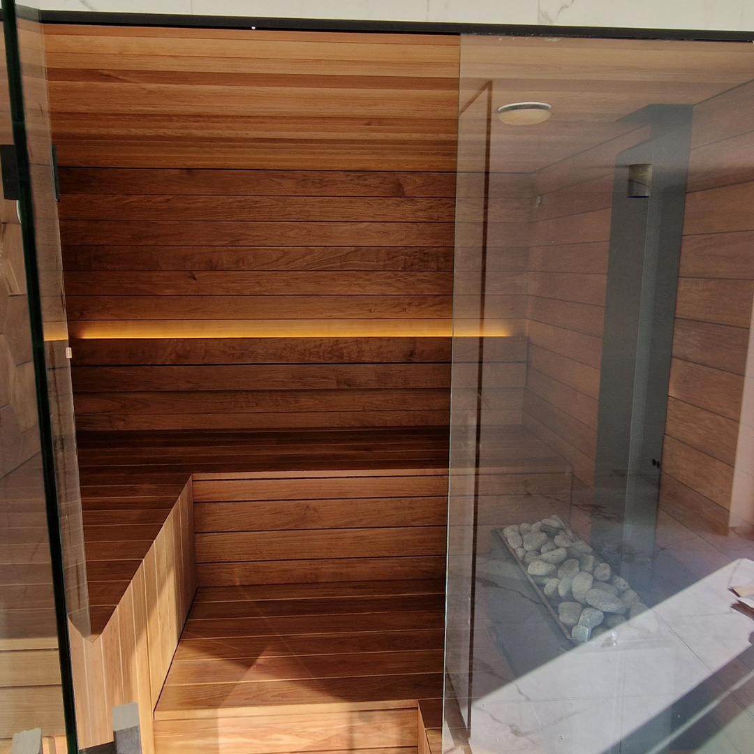 Wooden sauna with glass door and interior bench