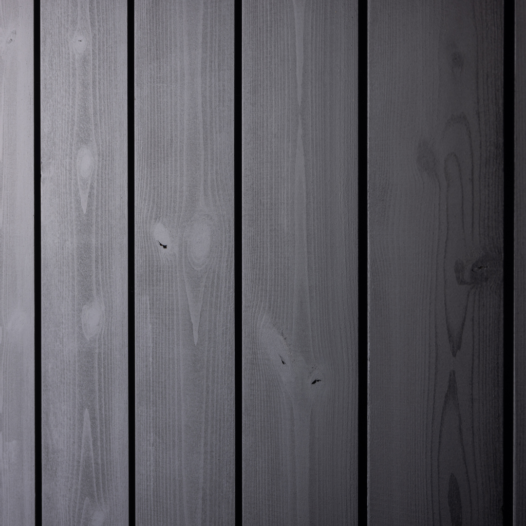 Dark wood paneling with visible grain texture and subtle knots. The vertical planks create a sleek, modern look, conveying a calm, minimalist tone.