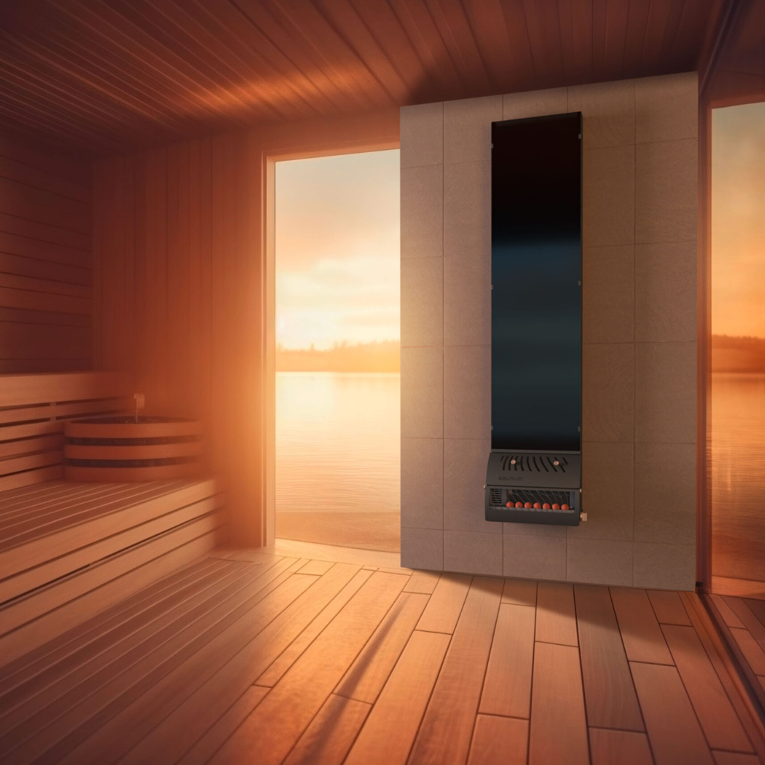 Warm wooden sauna interior with a heater against a tiled wall. Open door reveals a serene lake and sunset, creating a tranquil, inviting atmosphere.