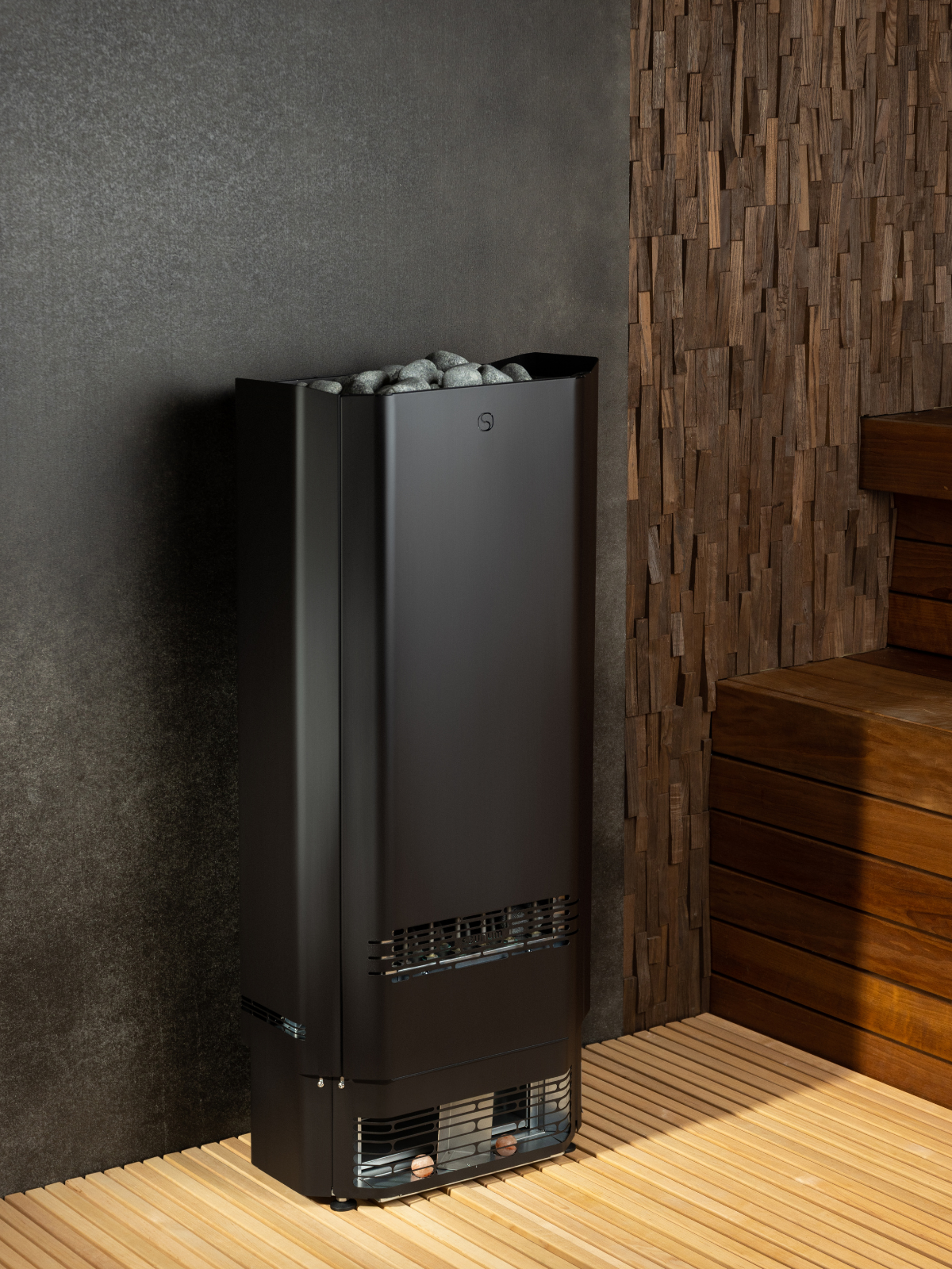 Black sauna heater against a dark wall with wooden accents