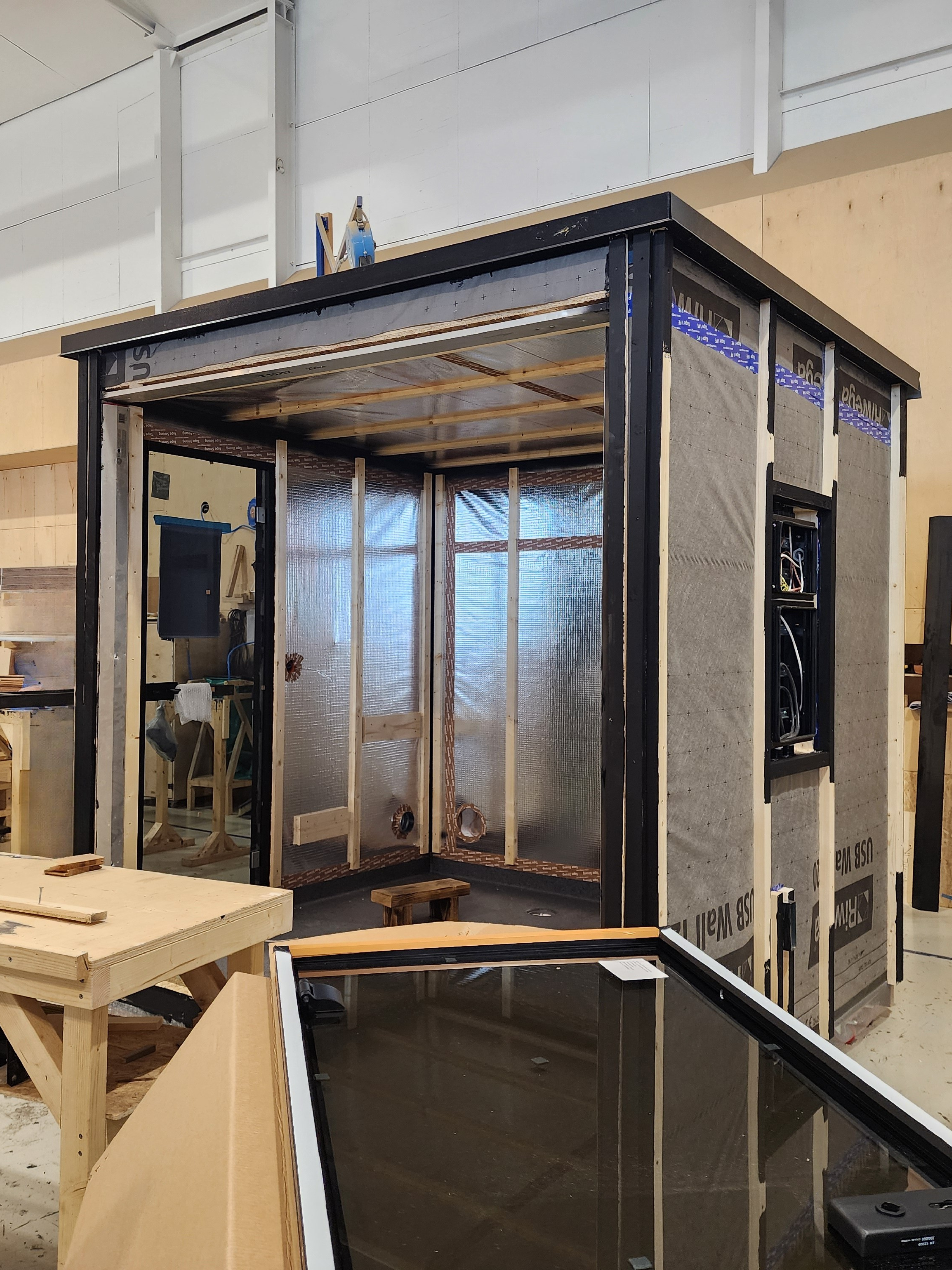 Woodworking workshop with a large workbench and cabinets.