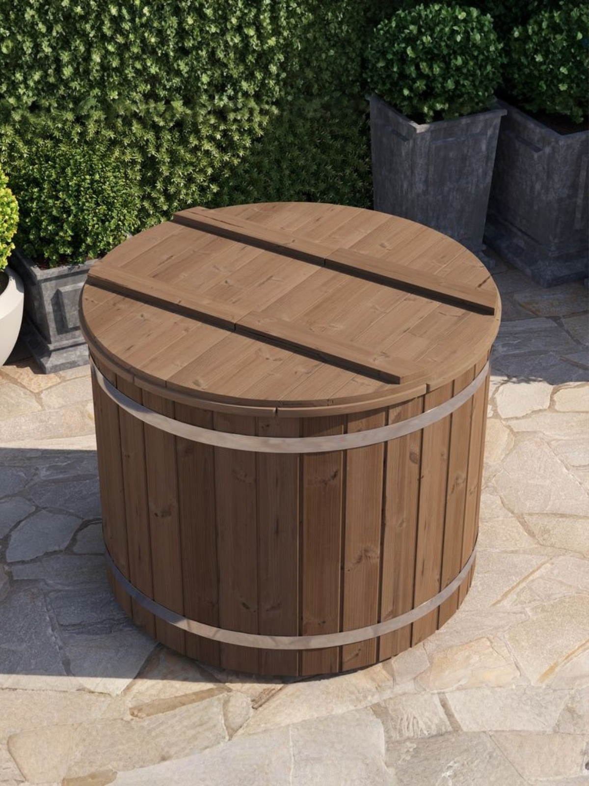 Wooden barrel-style table with a lid on a stone patio