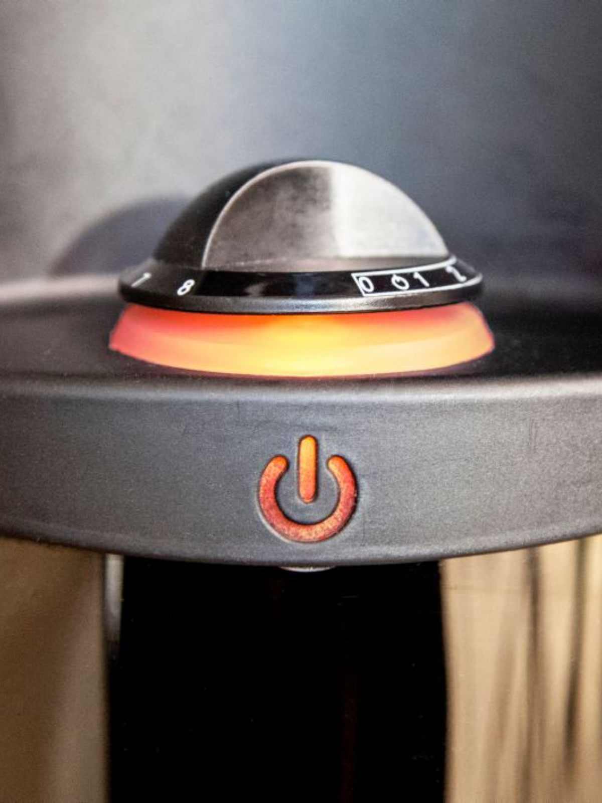 Close-up of a portable heater with a power symbol on a dark background
