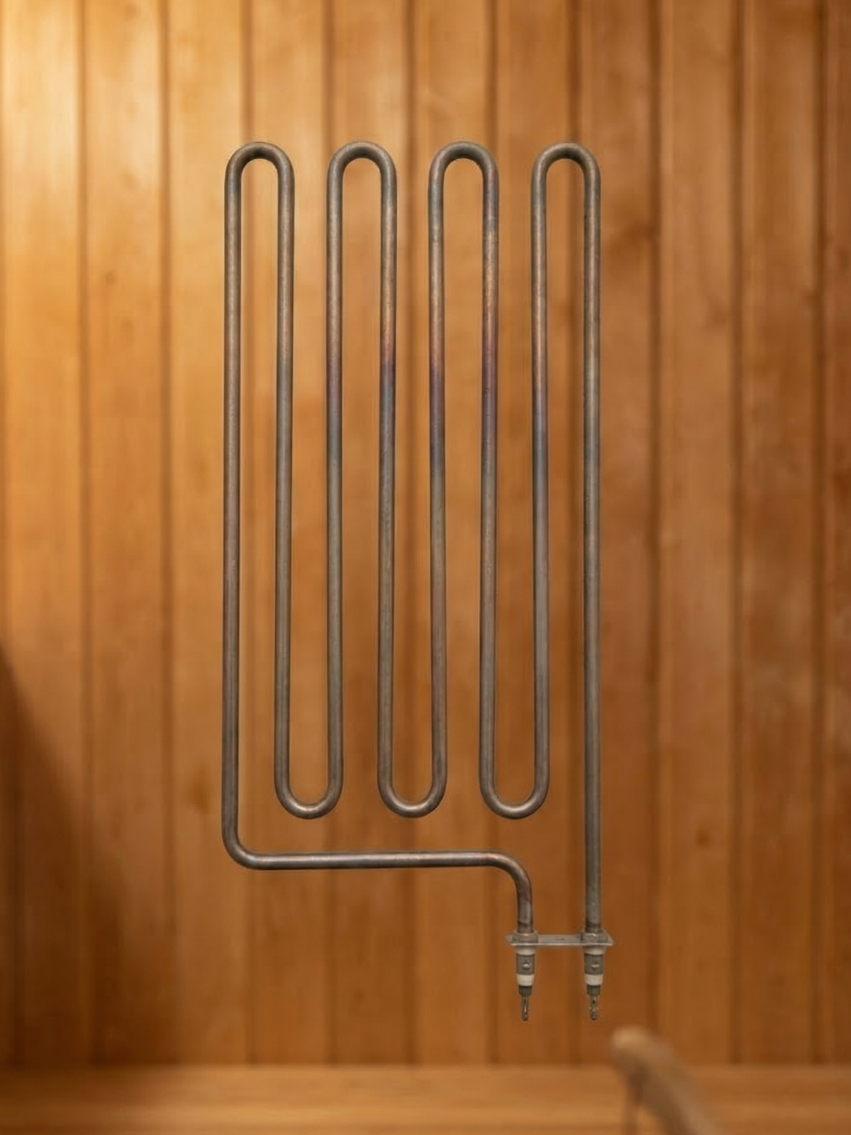 Metal heating element against a wooden background