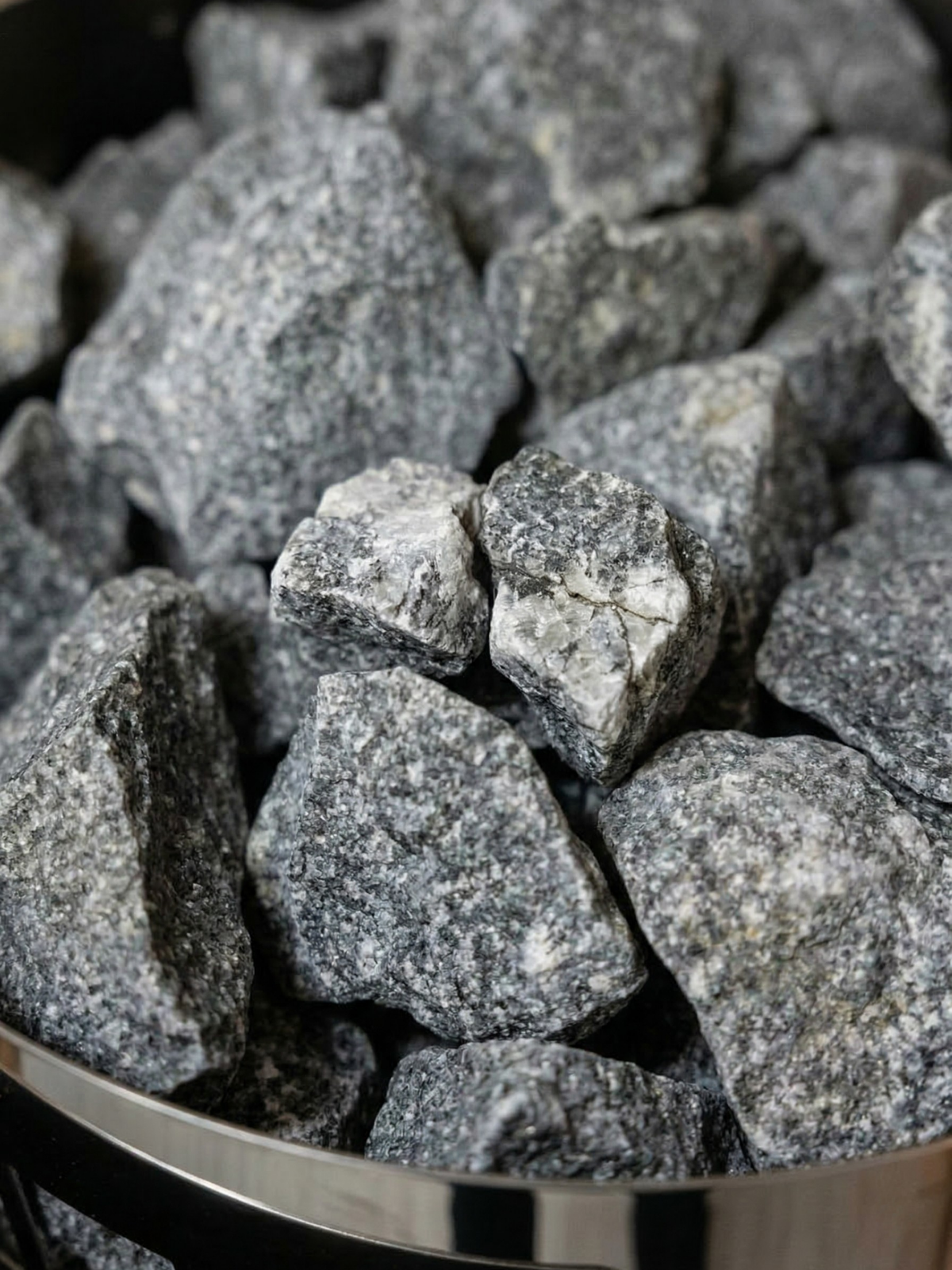 Close-up of gray stones in a metal container