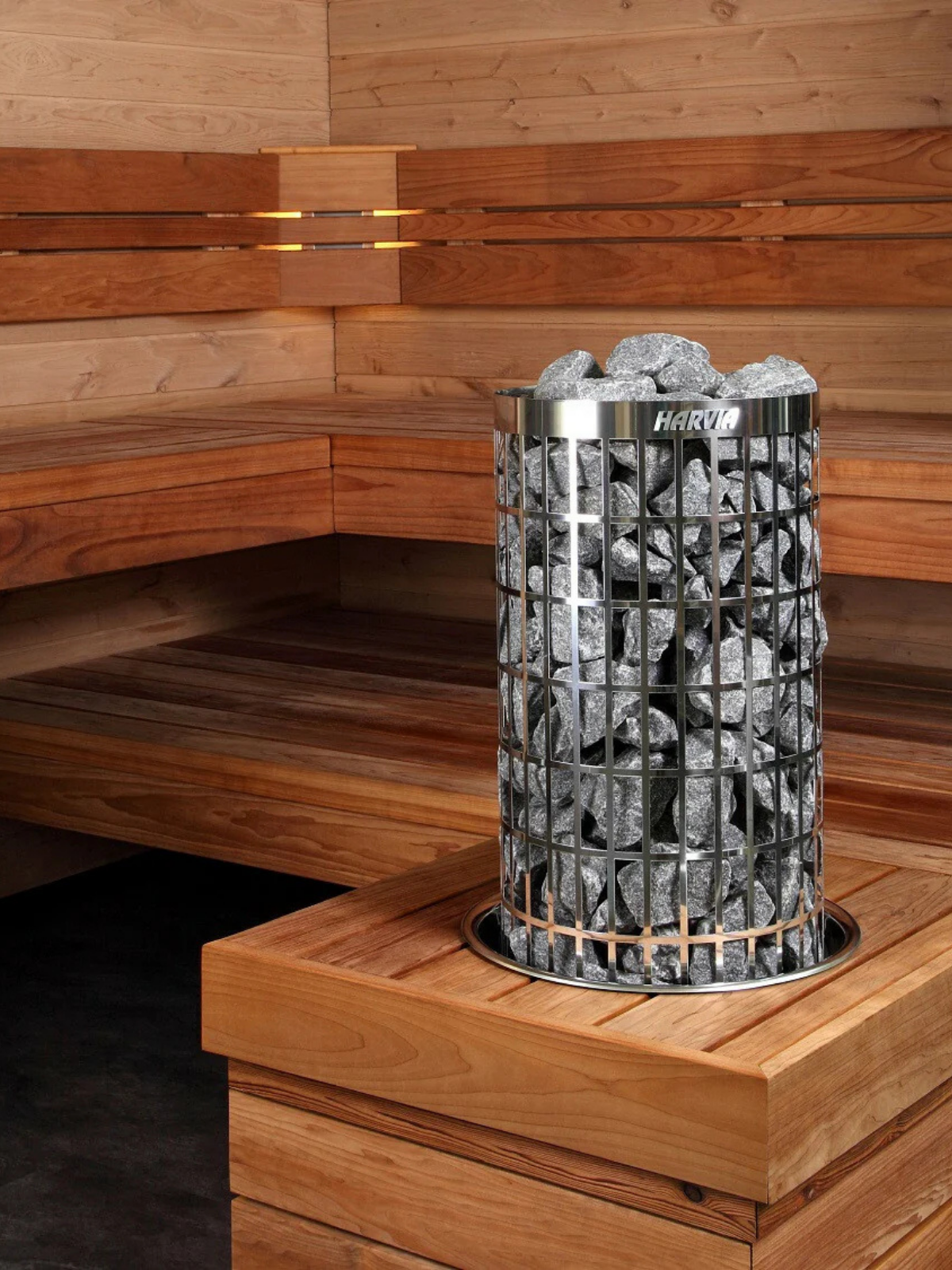 Heated stone basket on a wooden bench in a sauna setting