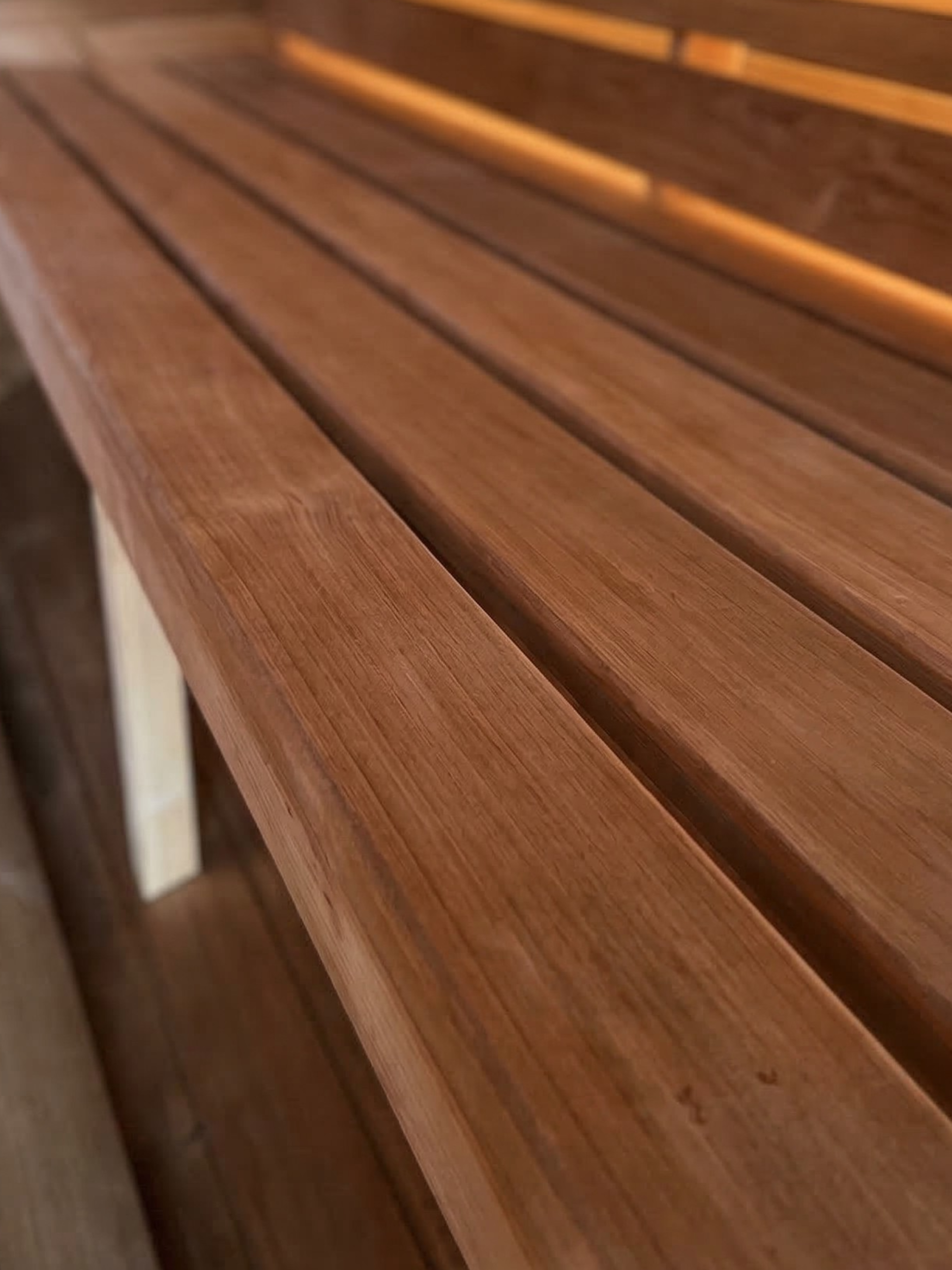 Close-up of a wooden bench with slatted design