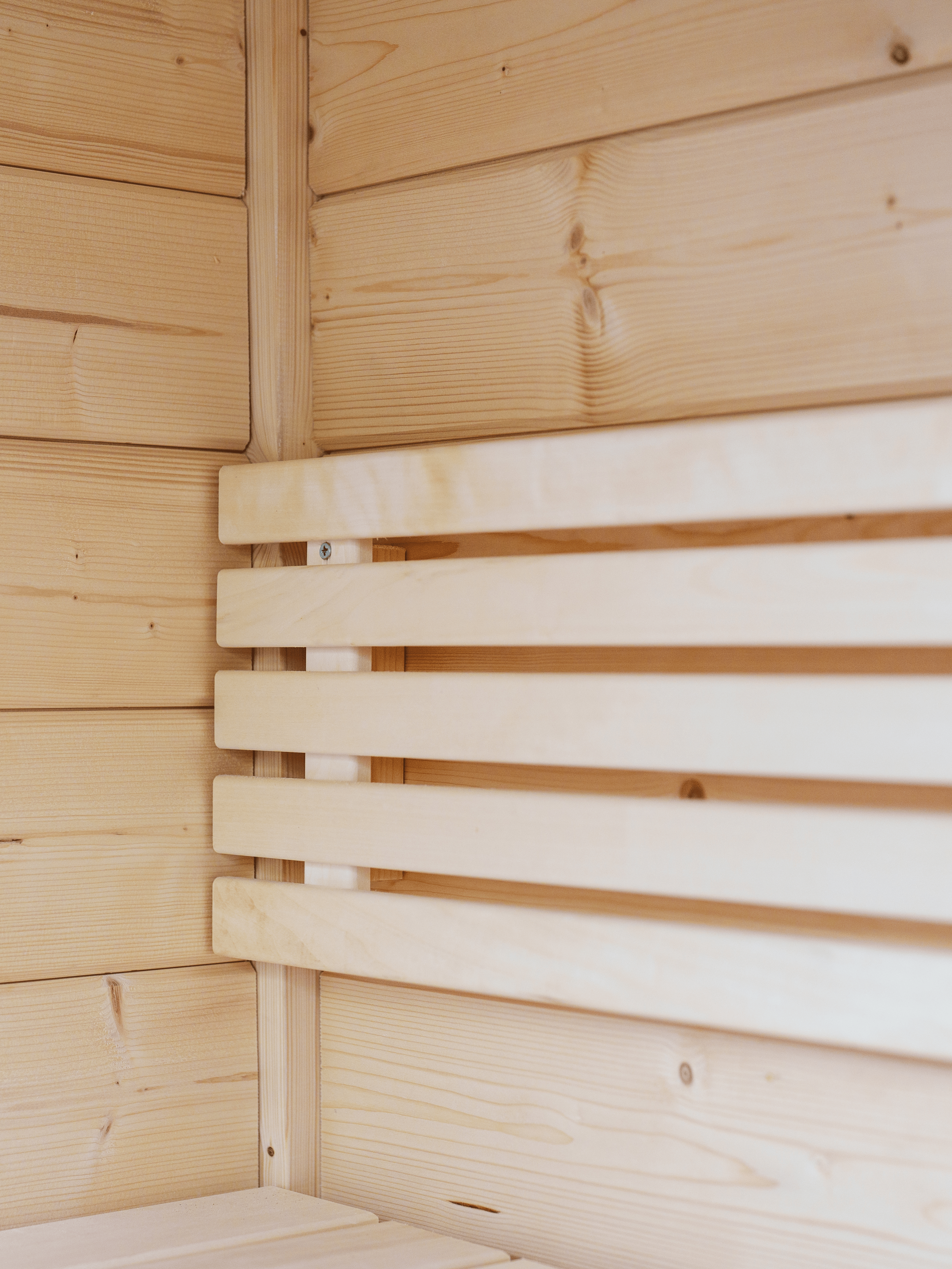 Wooden sauna interior with a bench and paneling