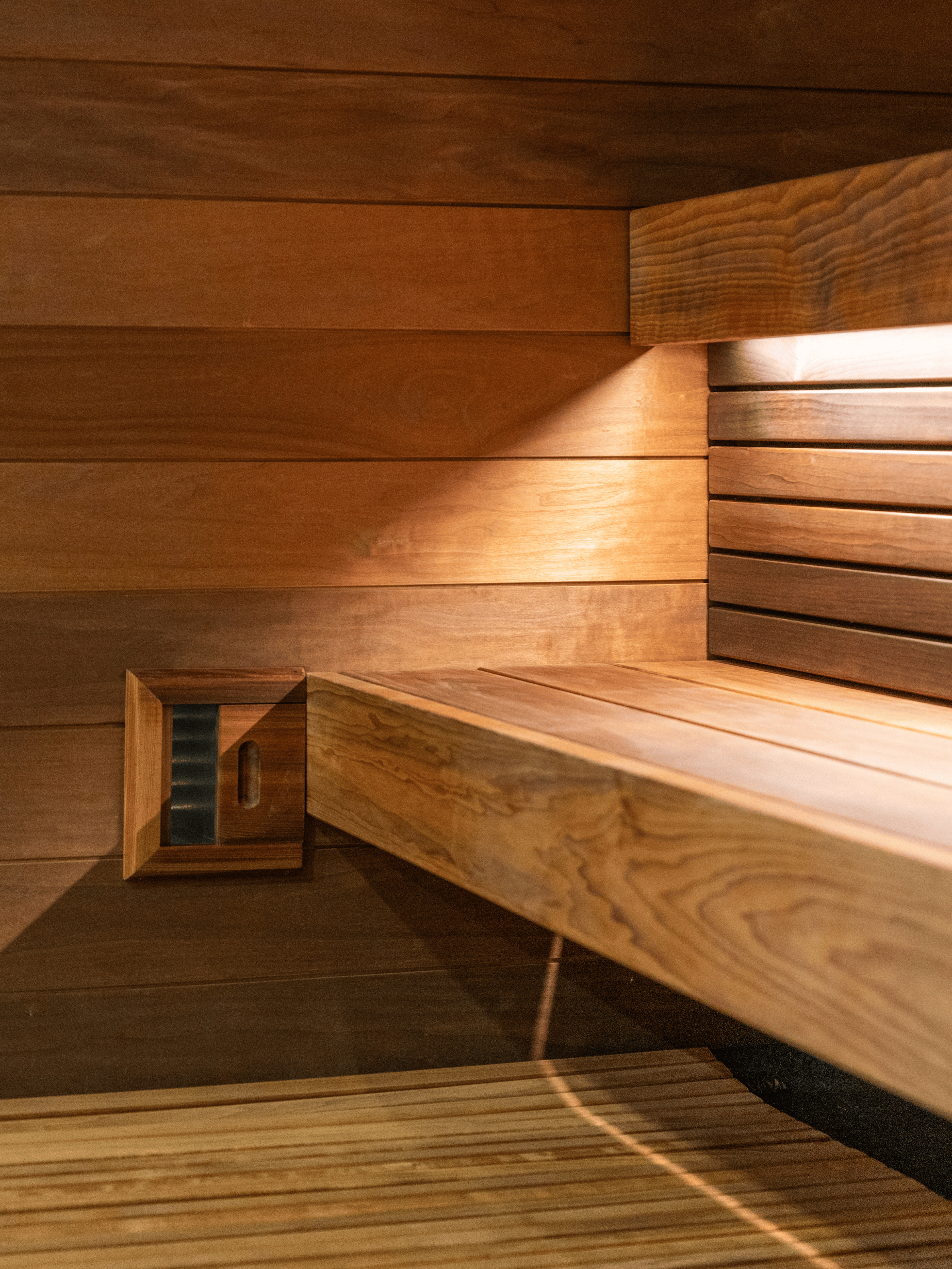 Wooden sauna interior with bench and wall paneling